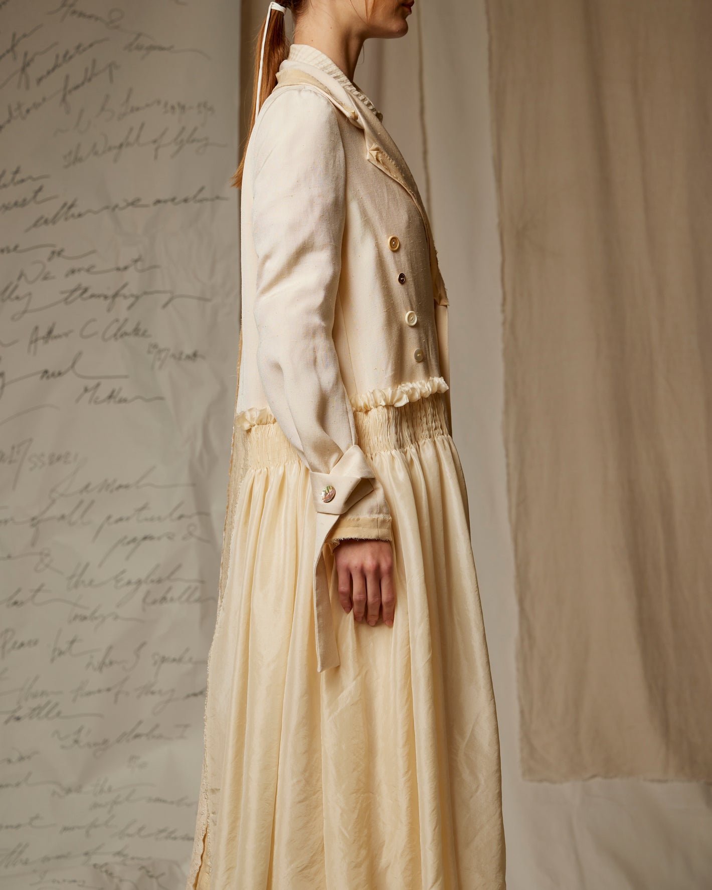 A Tentative Atelier AW22 Lookbook crop of white silk coat