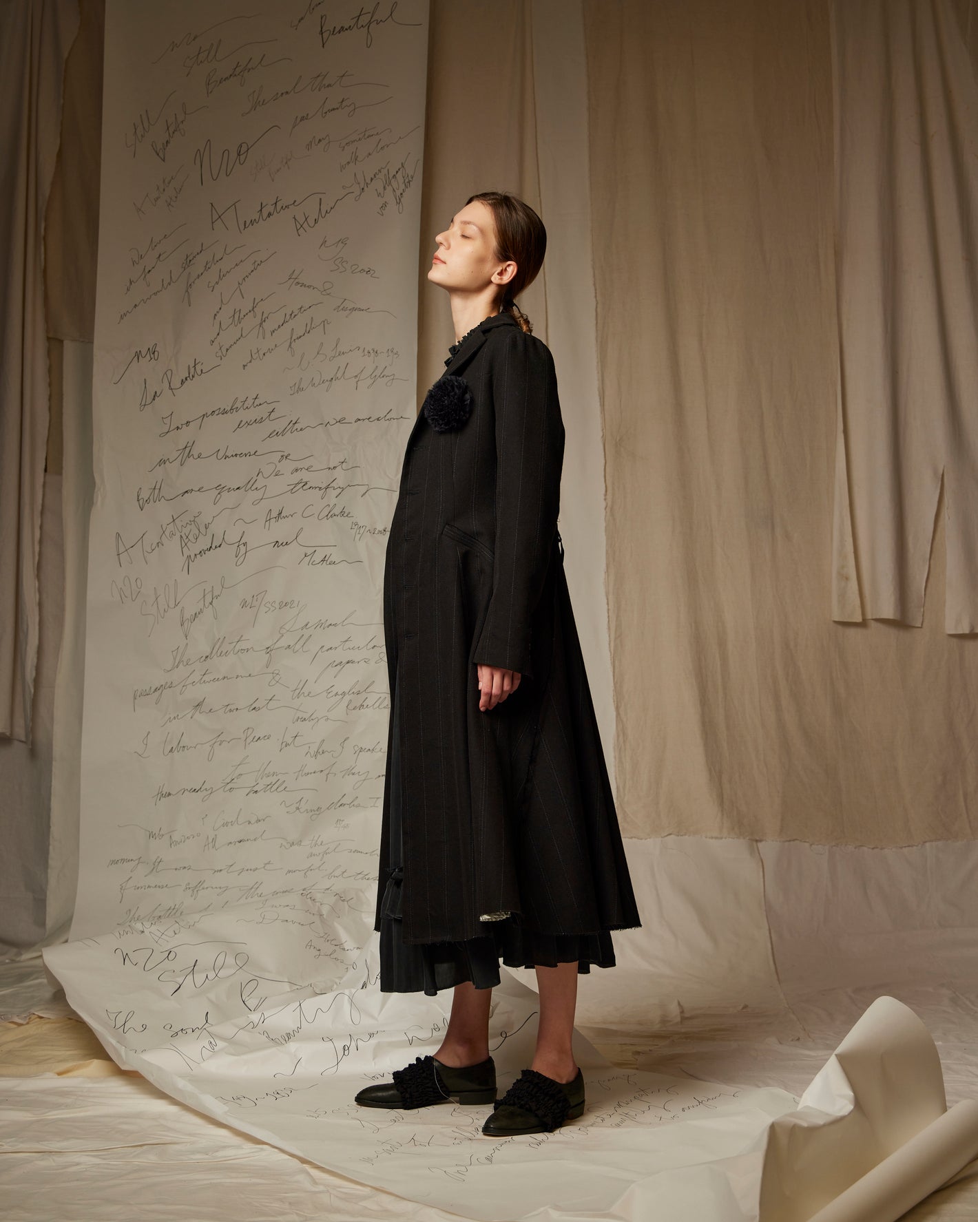A Tentative Atelier SS23 Lookbook Womens black long coat with flower appliqué on the chest