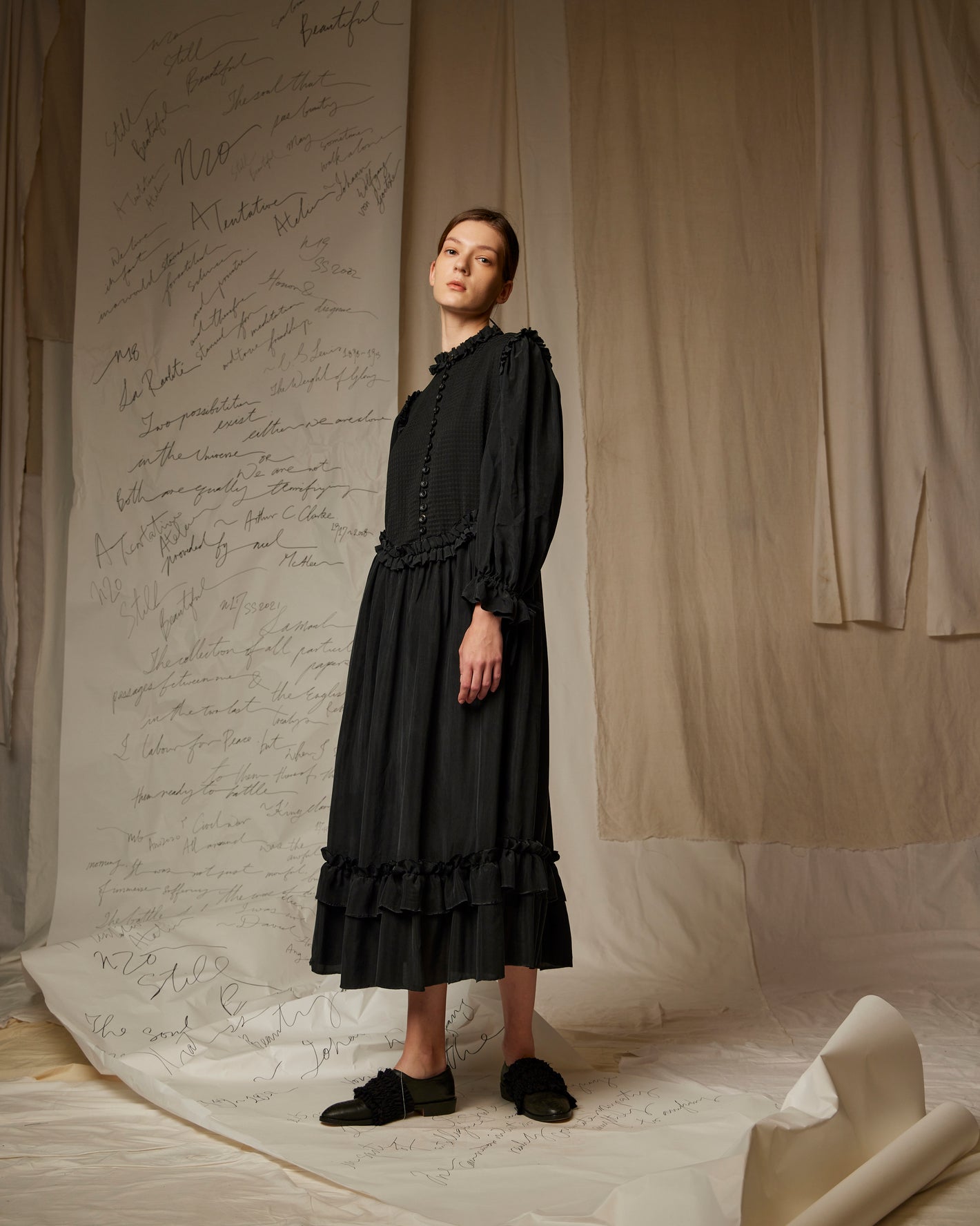 A Tentative Atelier SS23 Lookbook Womens black long sleeved dress with a ruffle collar and hem