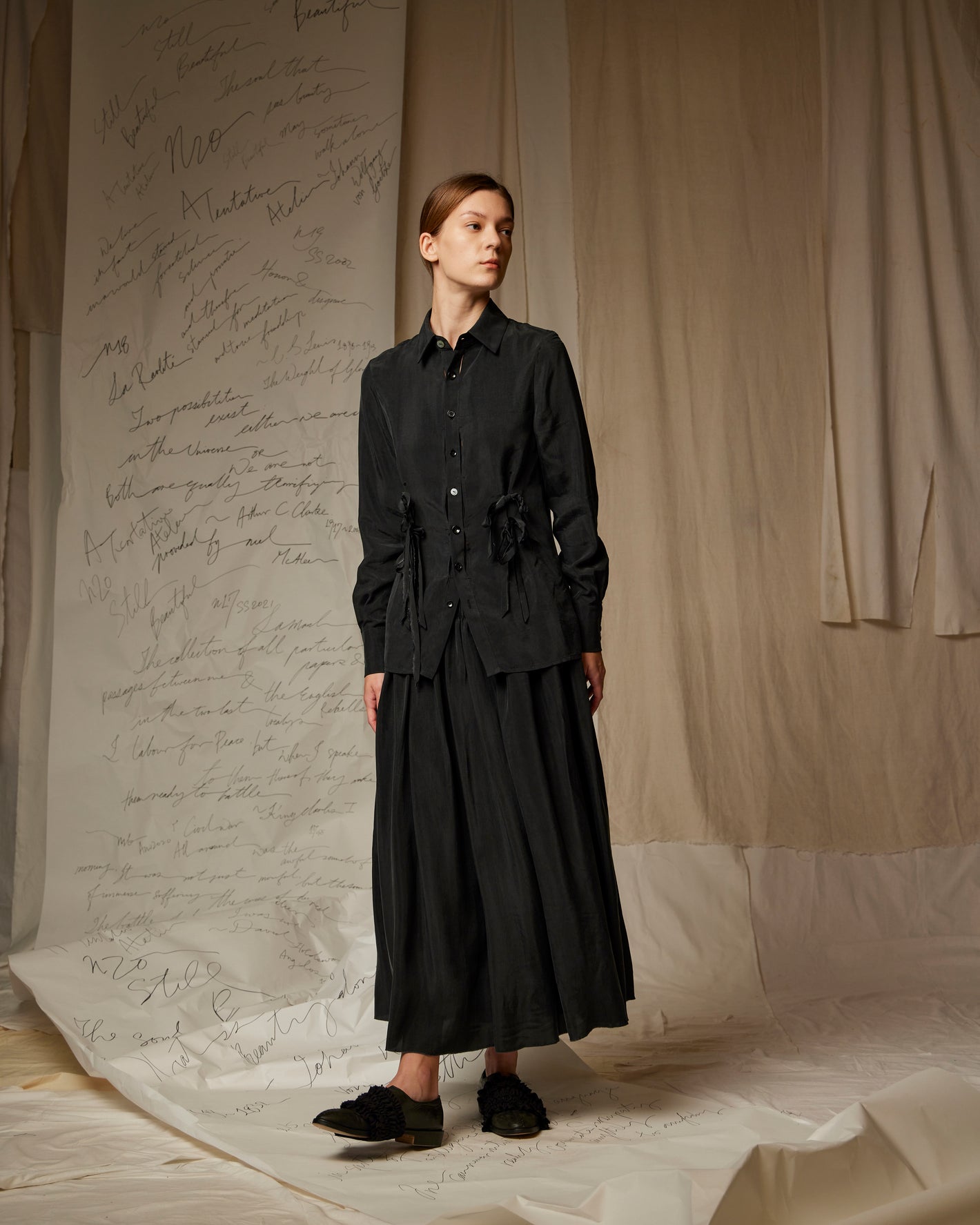 A Tentative Atelier SS23 Lookbook Womens black shirt featuring a gathered waist and black skirt ensemble