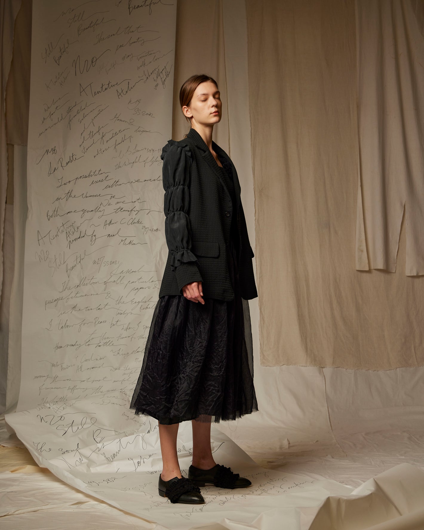 A Tentative Atelier SS23 Lookbook Womens black ruched sleeves jacket and embroidered black skirt ensemble