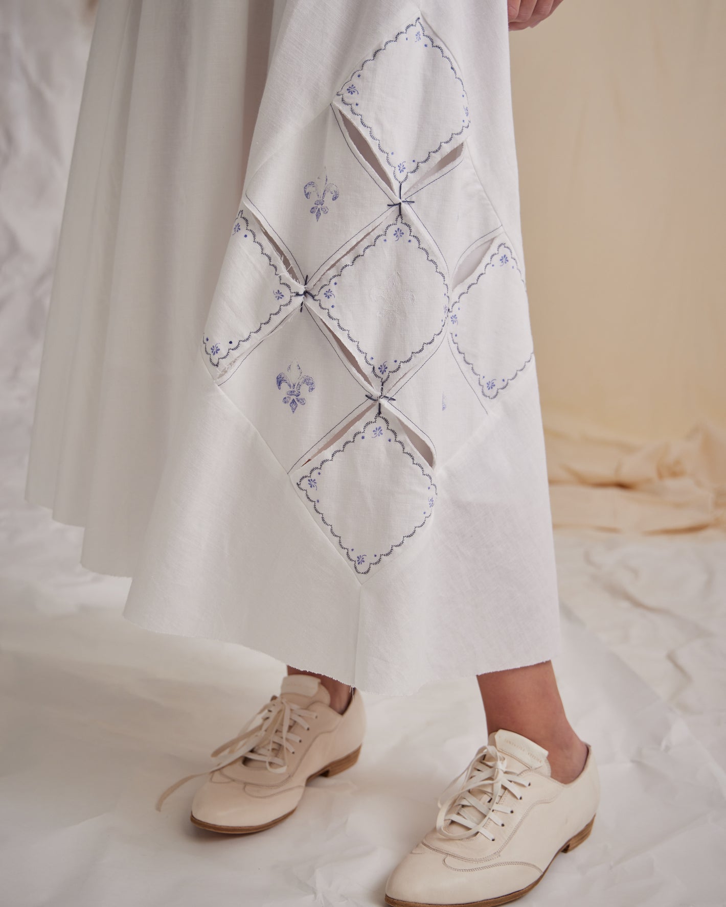 A Tentative Atelier SS23 Lookbook crop of Womens white skirt with a complex diamond detail