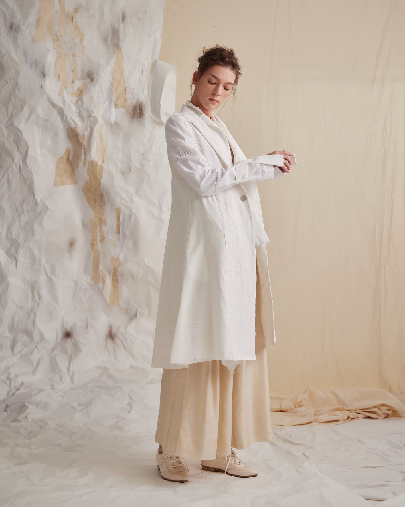 A Tentative Atelier SS23 Lookbook Womens white long coat and beige wide leg trousers ensemble