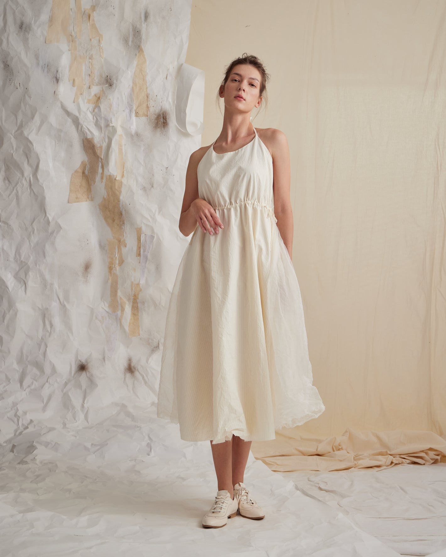 A Tentative Atelier SS23 Lookbook Womens off white strap dress with a ruched waist and semi-sheer layered skirt