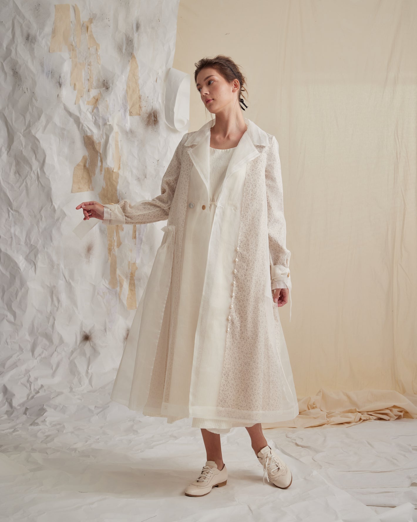A Tentative Atelier SS23 Lookbook Womens long layered coat featuring a white semi-sheer fabric layered over a small floral print fabric