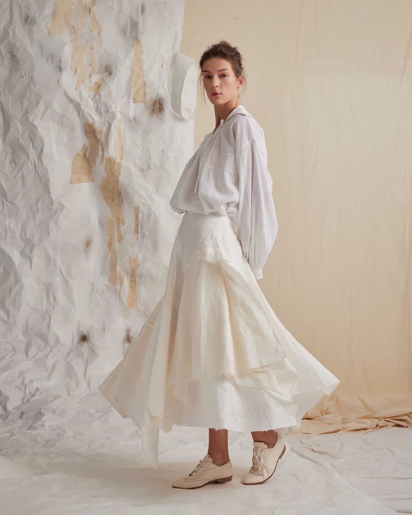 A Tentative Atelier SS23 Lookbook Womens white balloon sleeve shirt and cream layered skirt ensemble