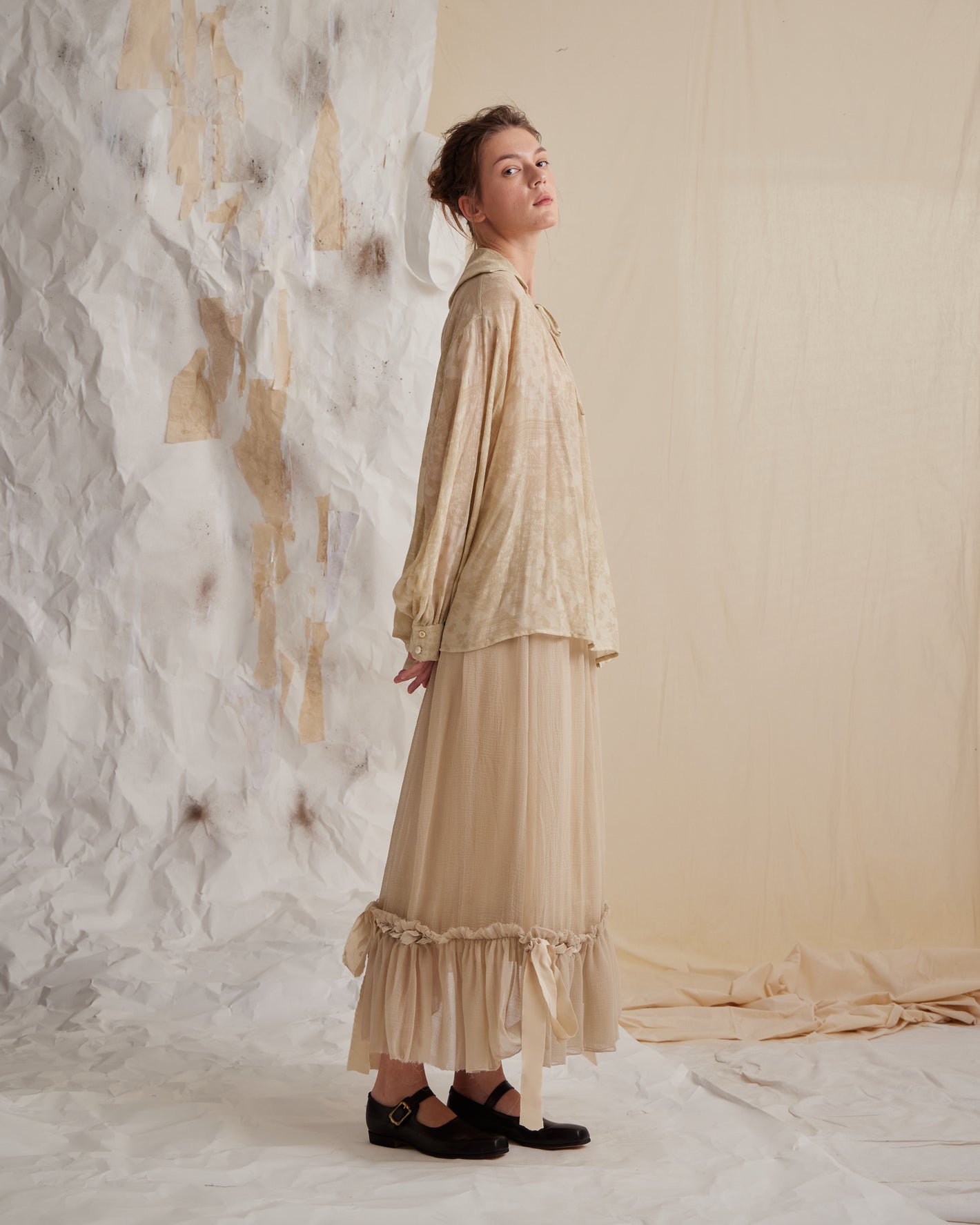 A Tentative Atelier SS23 Lookbook Womens beige patterned shirt and long beige dress with ruffle hem
