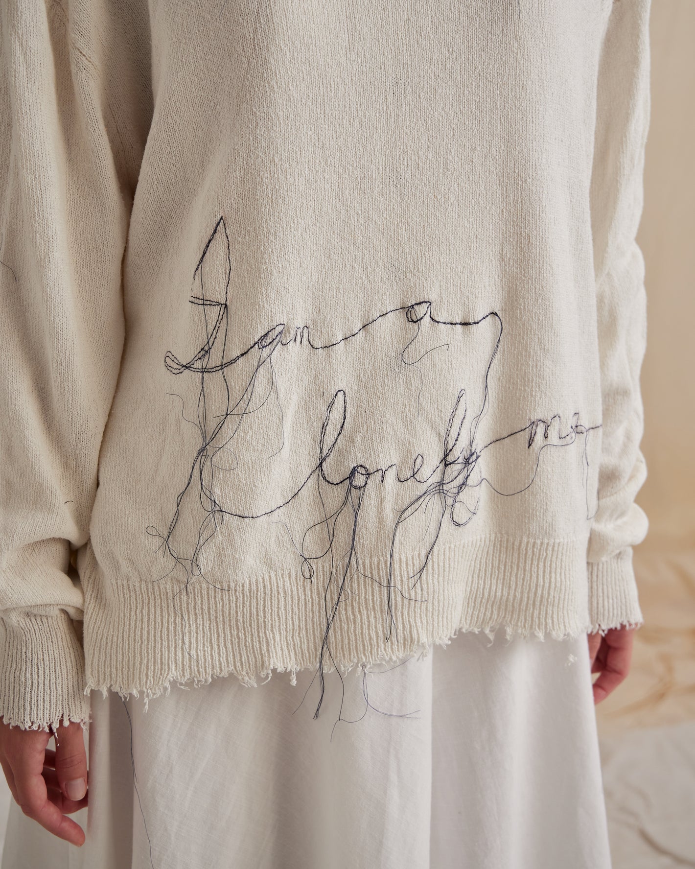 A Tentative Atelier SS23 Lookbook crop of white embroidered knitwear