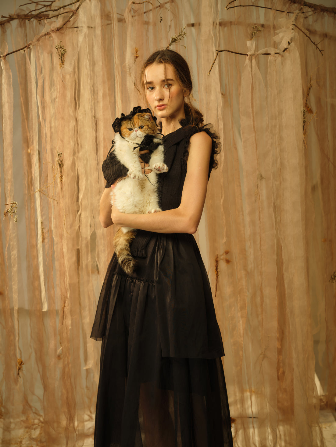 A Tentative Atelier SS21 Lookbook Womens crop of a sleeveless black dress with ruffle shoulders