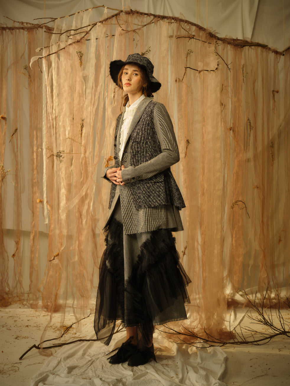 A Tentative Atelier SS21 Lookbook Womens multi layered look featuring a striped waistcoat, striped jacket and black tulle appliqué bottoms