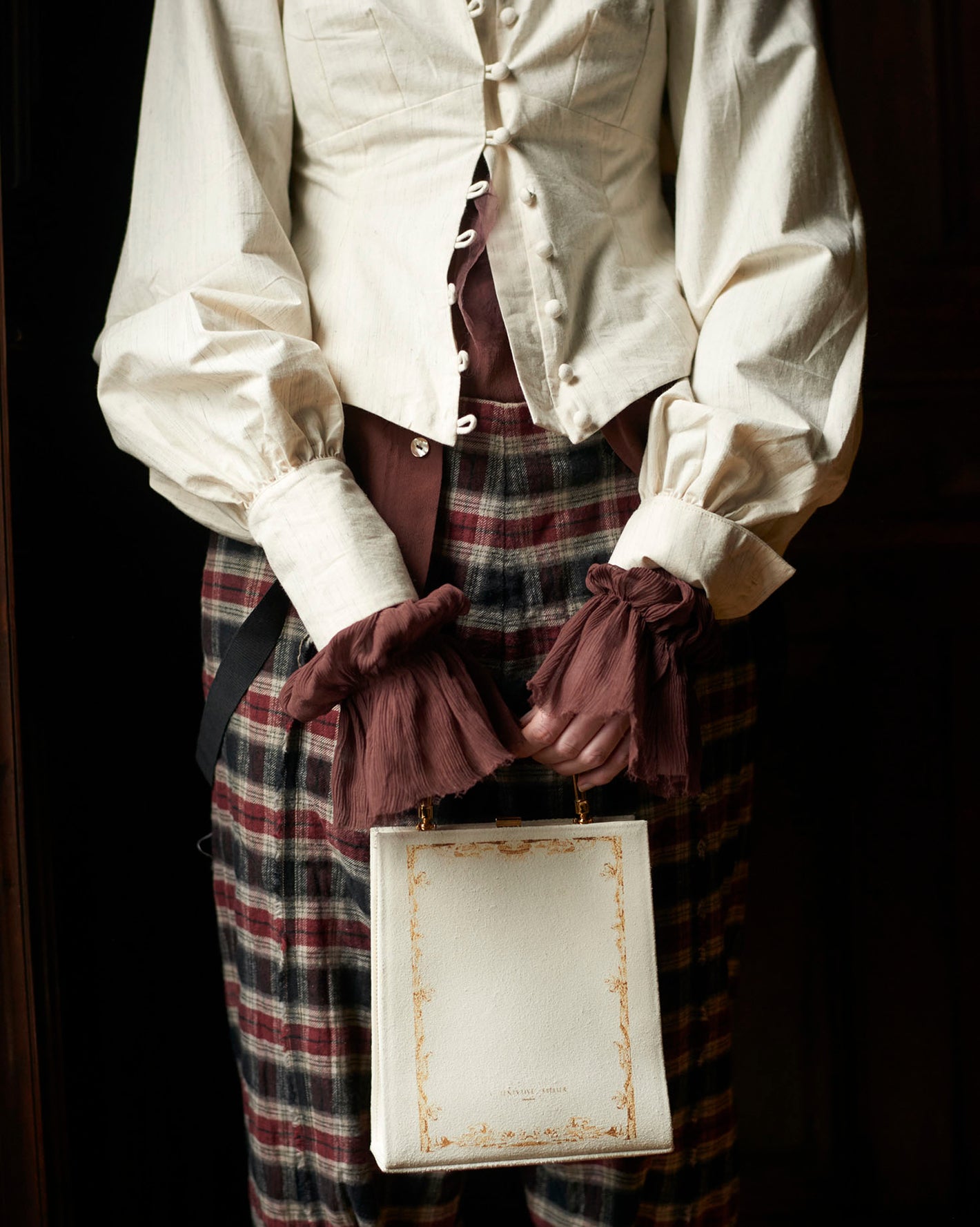 A Tentative Atelier AW20 Lookbook Womens crop of a white balloon sleeves top and white leather top handle purse