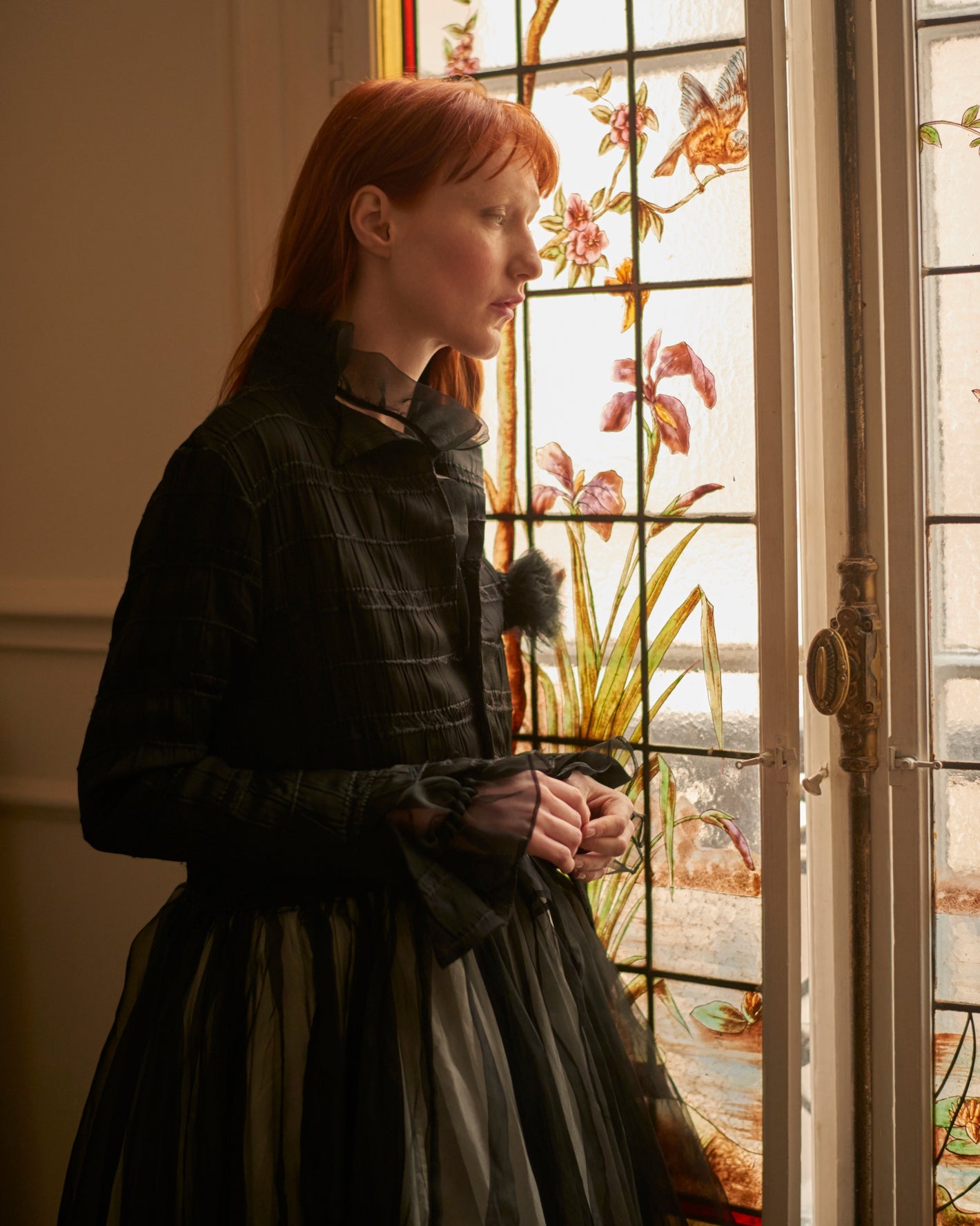 A Tentative Atelier AW20 Lookbook crop of black tulle coat with flower appliqué