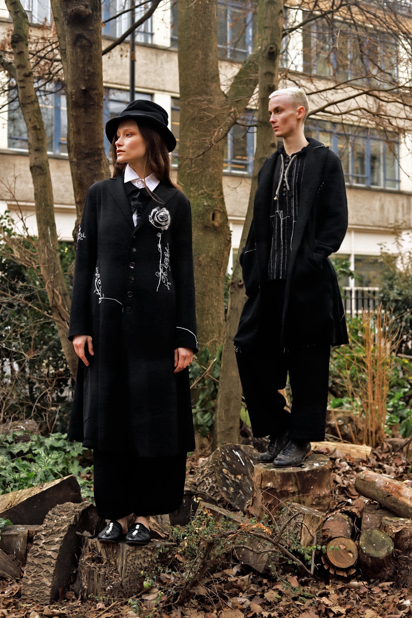 A Tentative Atelier AW23 Lookbook Womens black embroidered long coat and Mens black coat