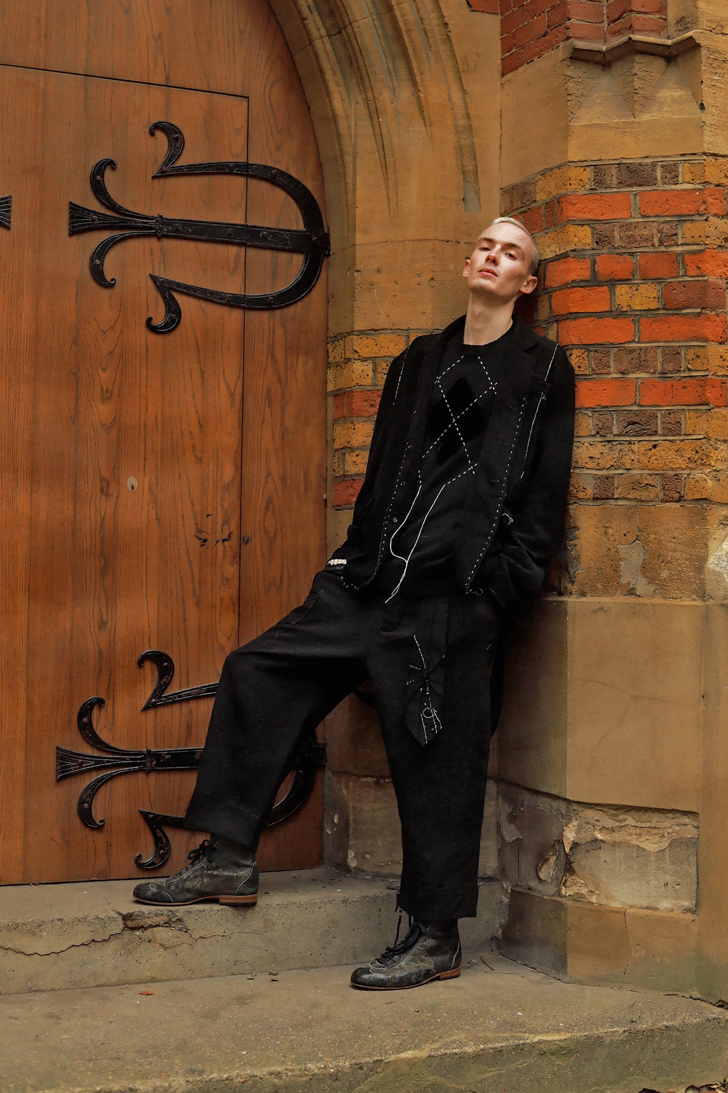 A Tentative Atelier AW23 Lookbook Mens black jacket and embroidered detail jumper look