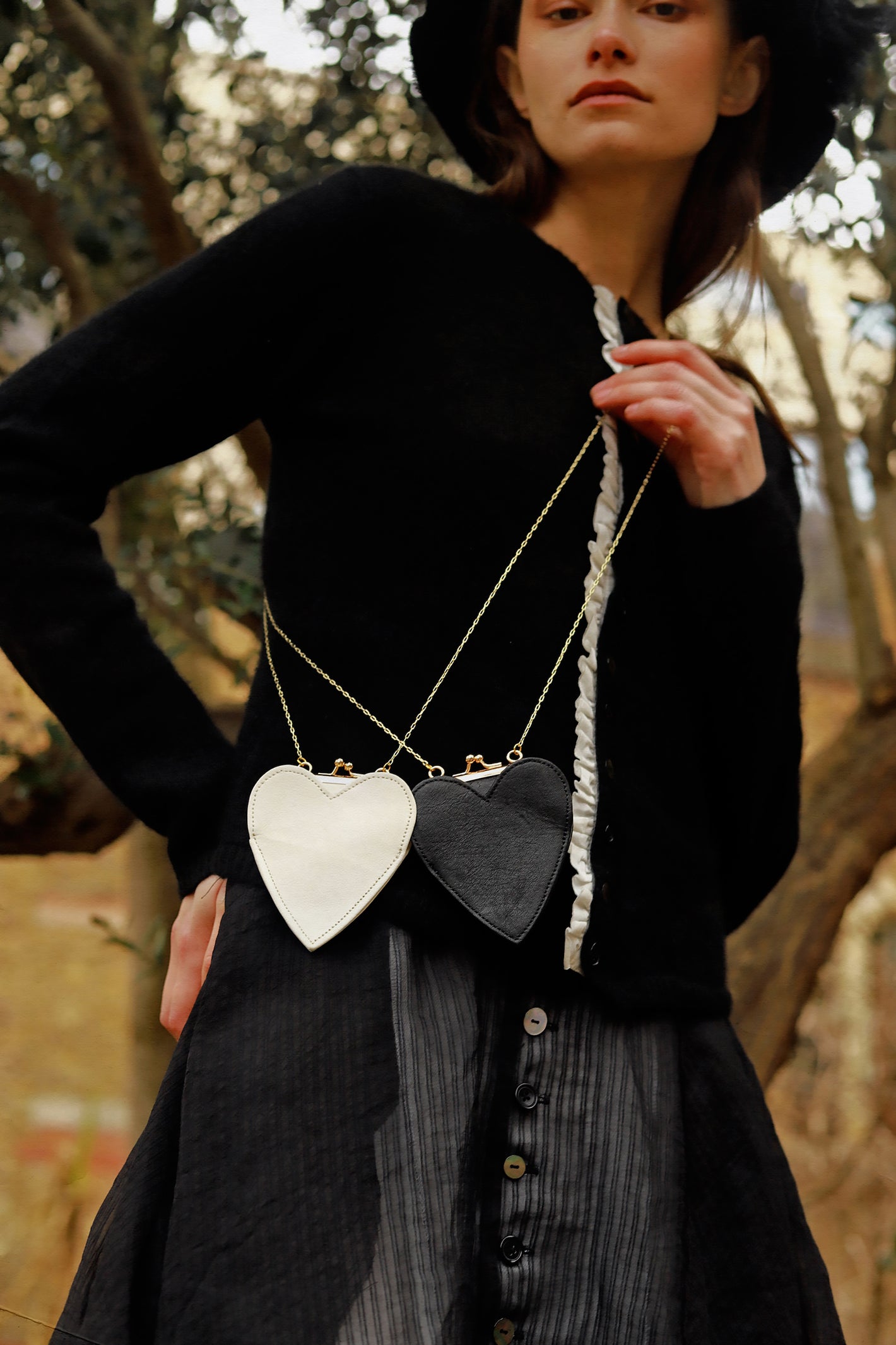 A Tentative Atelier AW23 Lookbook crop of Womens mini heart shaped side body purses