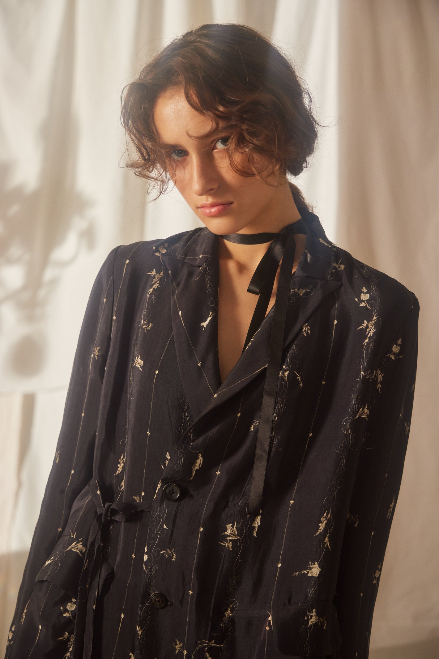 A Tentative Atelier SS22 Lookbook crop of black patterned jacket