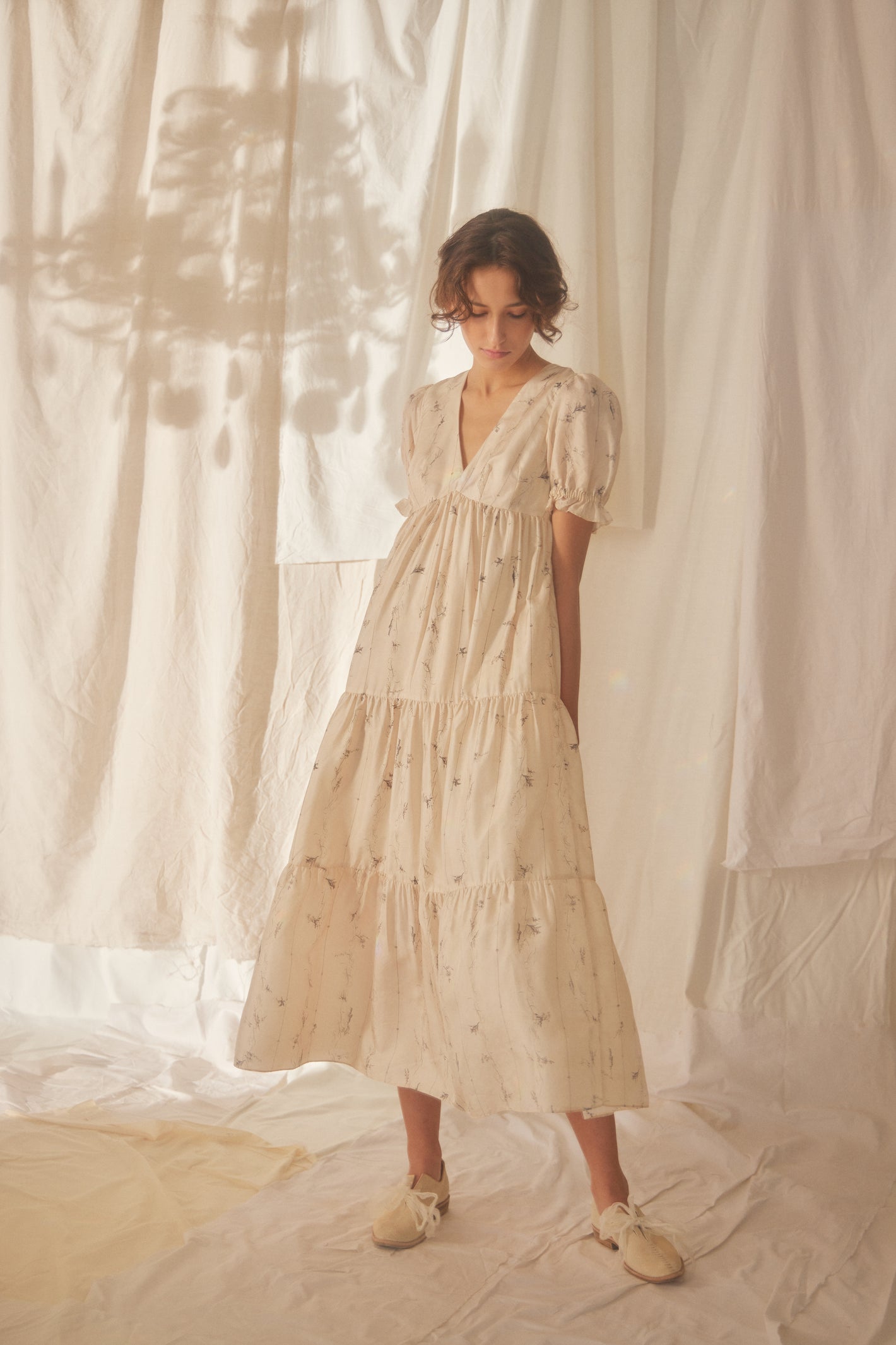 A Tentative Atelier SS22 Lookbook cream printed cap sleeve tiered dress