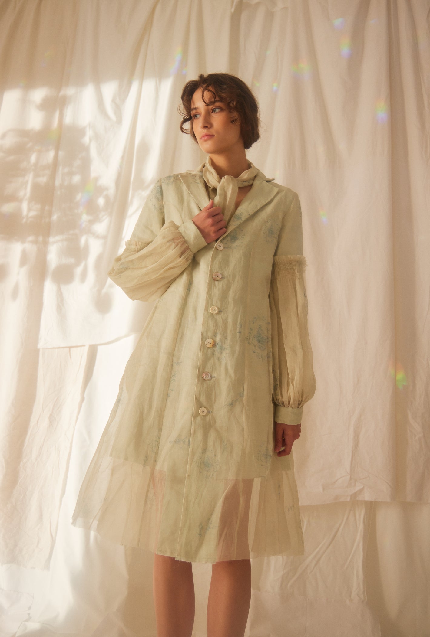 A Tentative Atelier SS22 Lookbook crop of sheer sleeves coat in grey/green