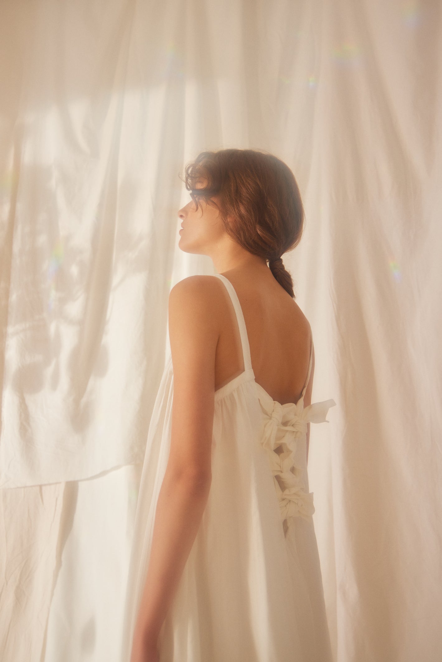 A Tentative Atelier SS22 Lookbook crop of white back ribbon ties dress