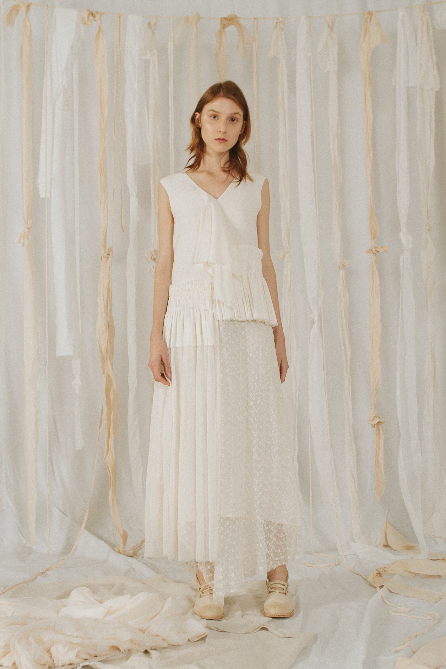 A Tentative Atelier SS18 Lookbook Womens white v-neck sleeveless dress with smocked appliqué and sheer lace skirt