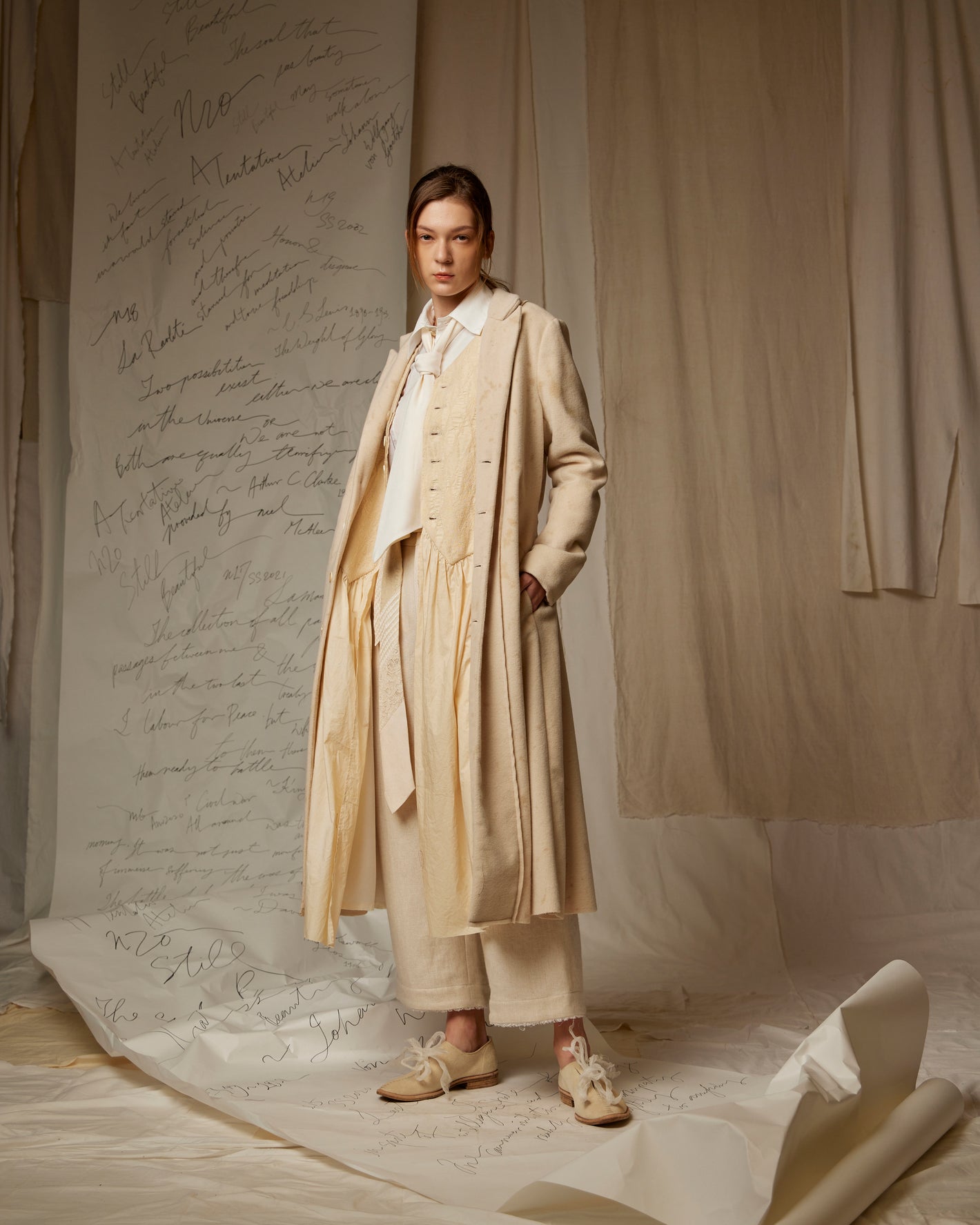 A Tentative Atelier AW22 Lookbook Womens beige coat, waistcoat and trousers ensemble