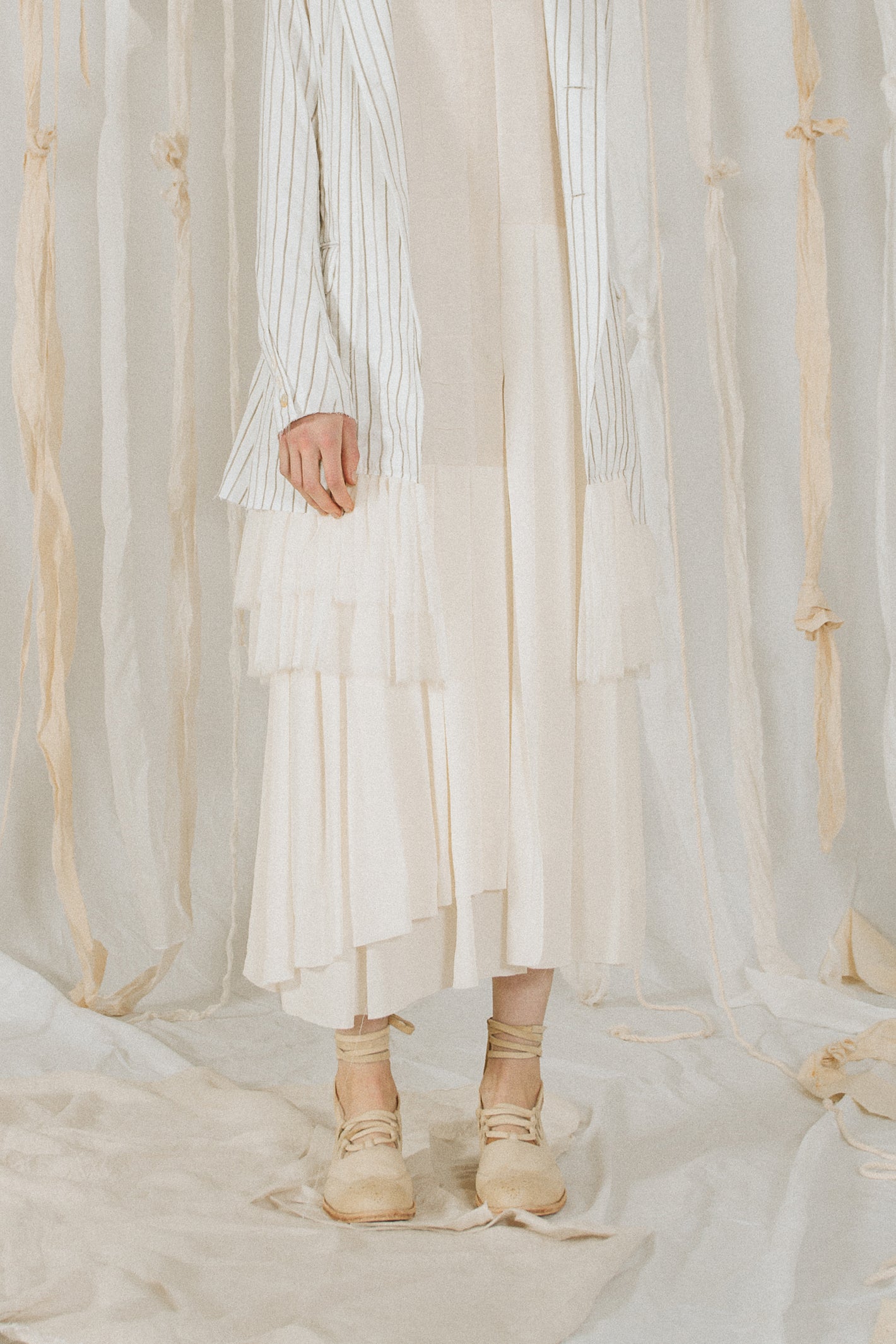 A Tentative Atelier SS18 Lookbook Womens crop of a white multi layered dress hem