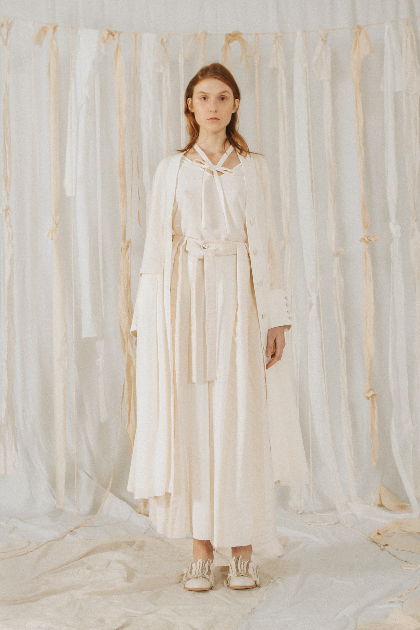 A Tentative Atelier SS18 Lookbook Womens long white coat and white belted trousers