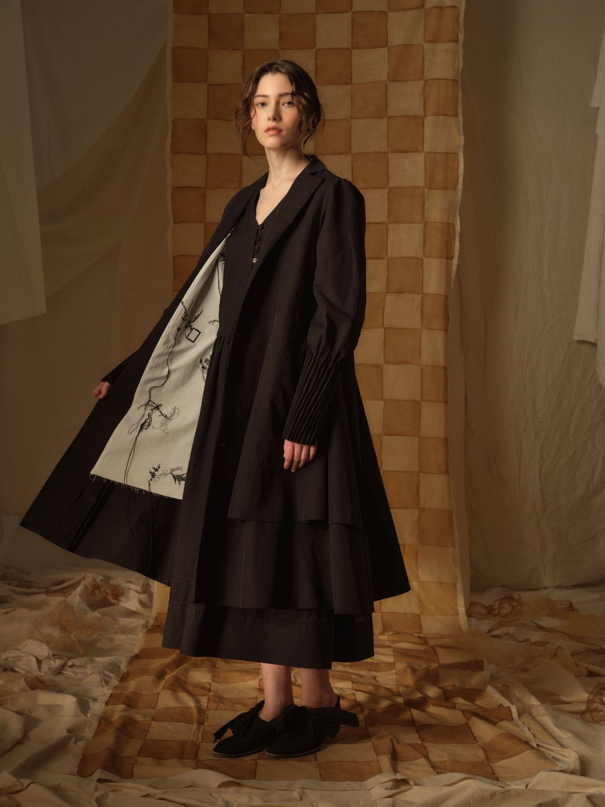 A Tentative Atelier AW21 Lookbook Womens black multi layered long coat with contrasting white lining