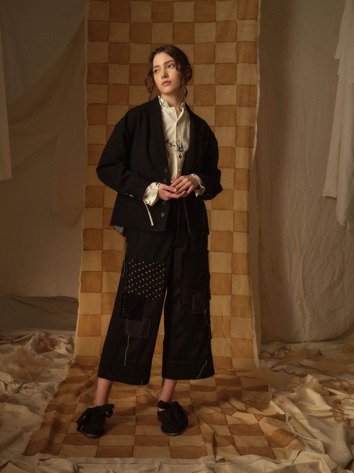 A Tentative Atelier AW21 Lookbook Womens black jacket and black patchwork trousers
