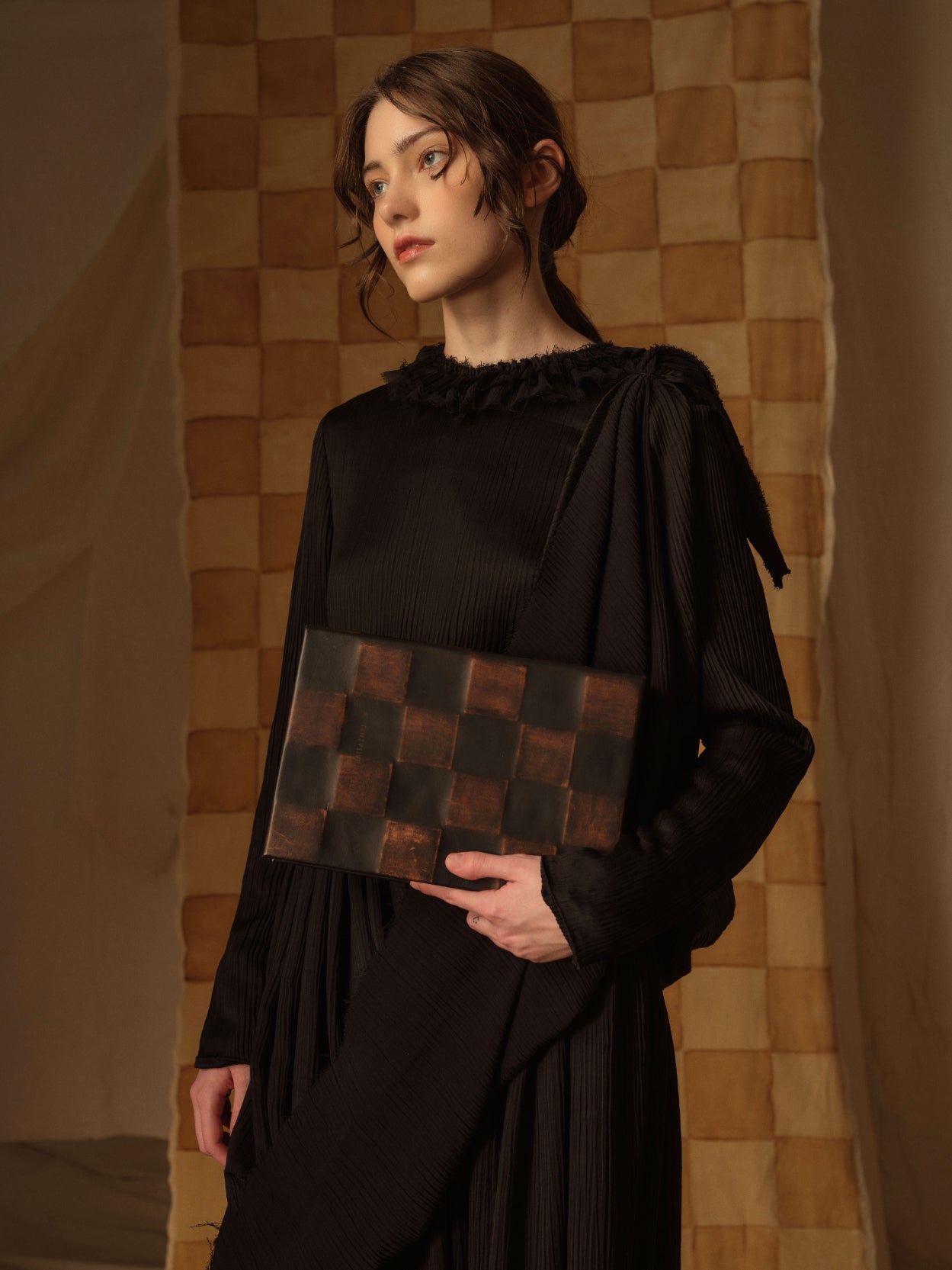 A Tentative Atelier AW21 Lookbook Womens crop of black and brown check leather clutch