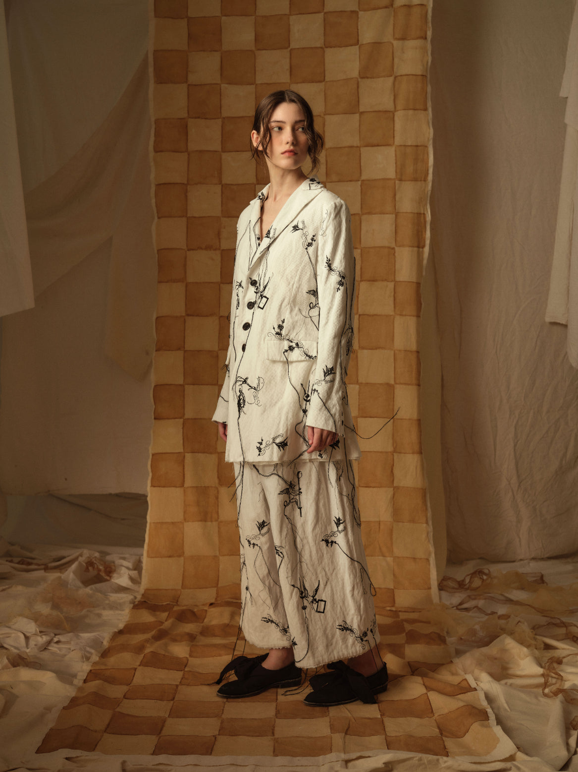 A Tentative Atelier AW21 Lookbook Womens white suit with black embroidery