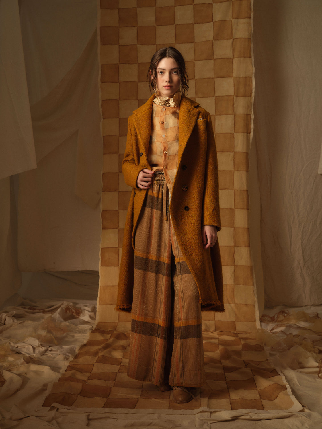 A Tentative Atelier AW21 Lookbook Womens burnt orange coat and wide check brown and orange trousers