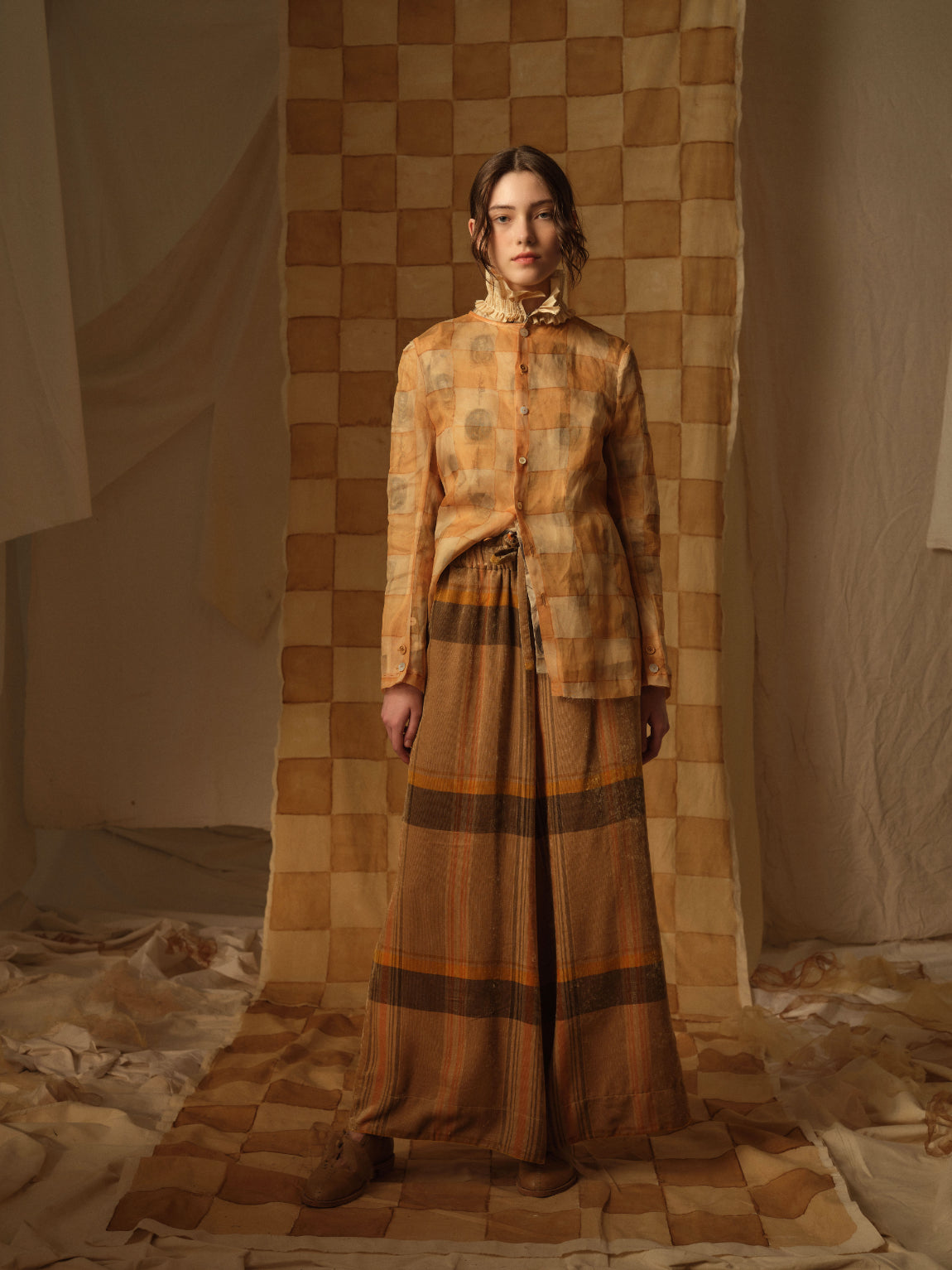 A Tentative Atelier AW21 Lookbook Womens orange check shirt with ruffle collar and wide leg orang brown check stripe trousers
