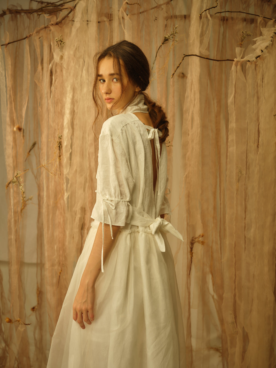 A Tentative Atelier SS21 Lookbook Womens crop of the back of a white dress with back ties and elbow length sleeves