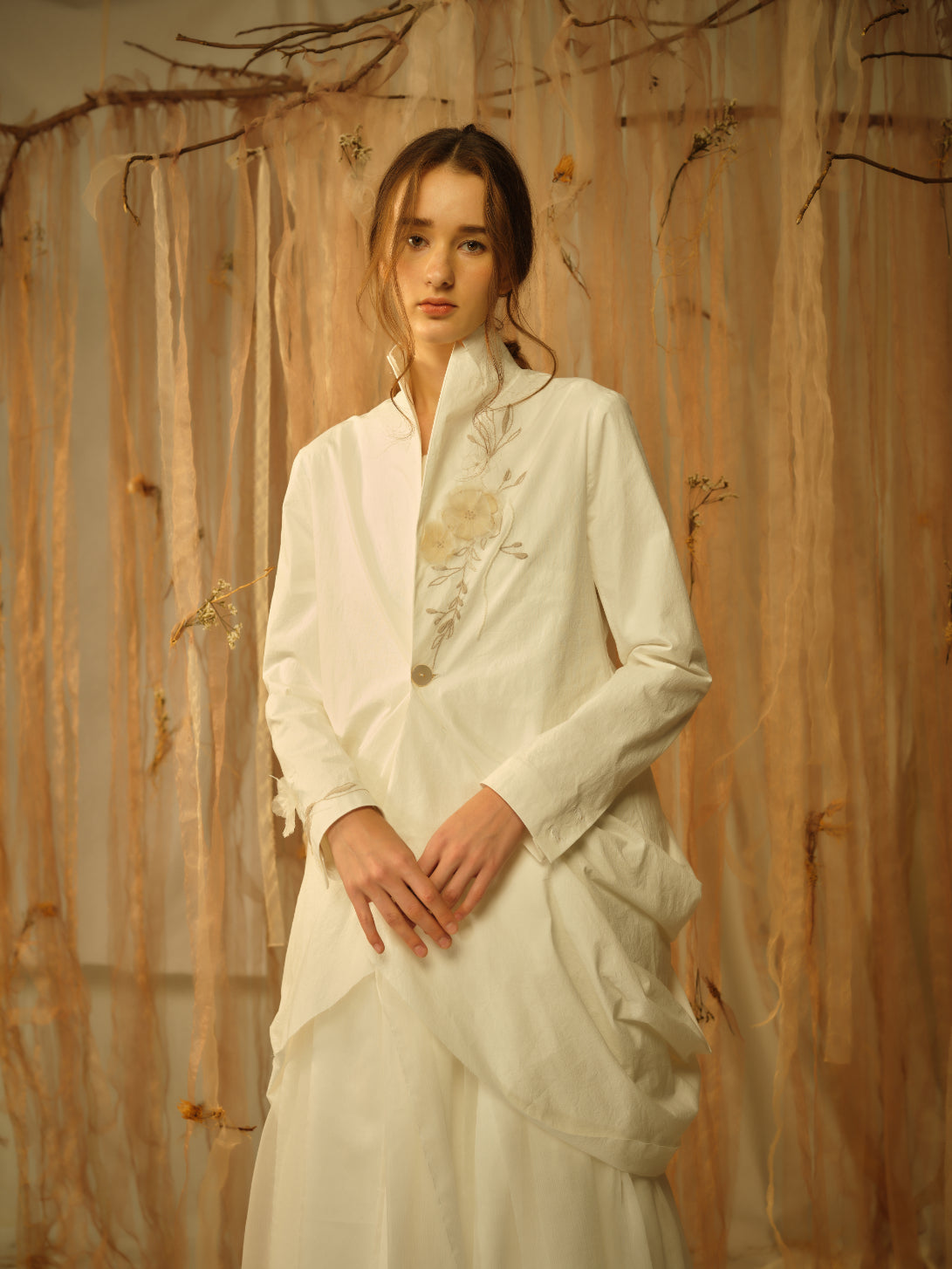 A Tentative Atelier SS21 Lookbook Womens crop of a white draped jacket with floral embroidery on the chest