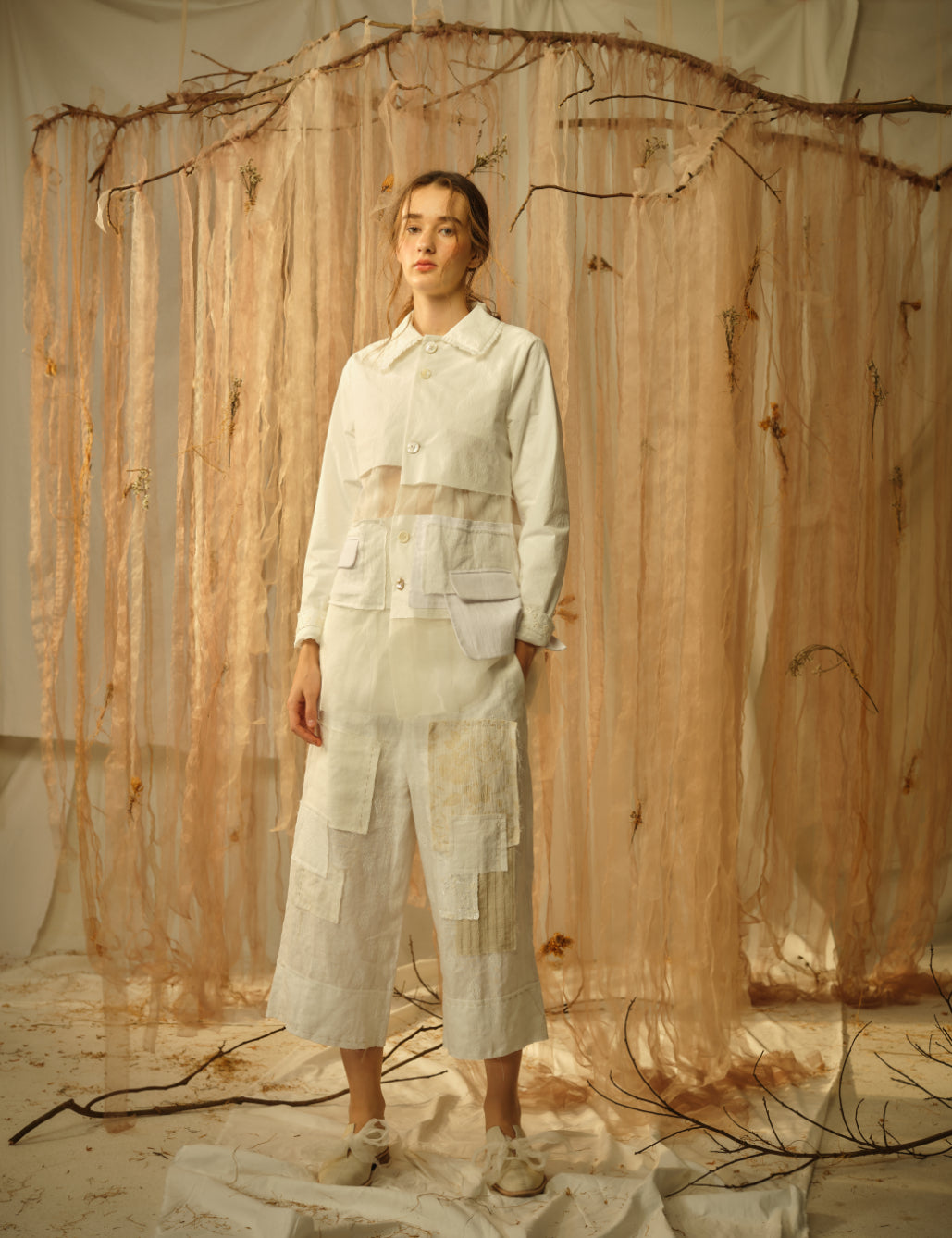 A Tentative Atelier SS21 Lookbook Womens white patchwork jacket with a sheer panel and white patchwork trousers