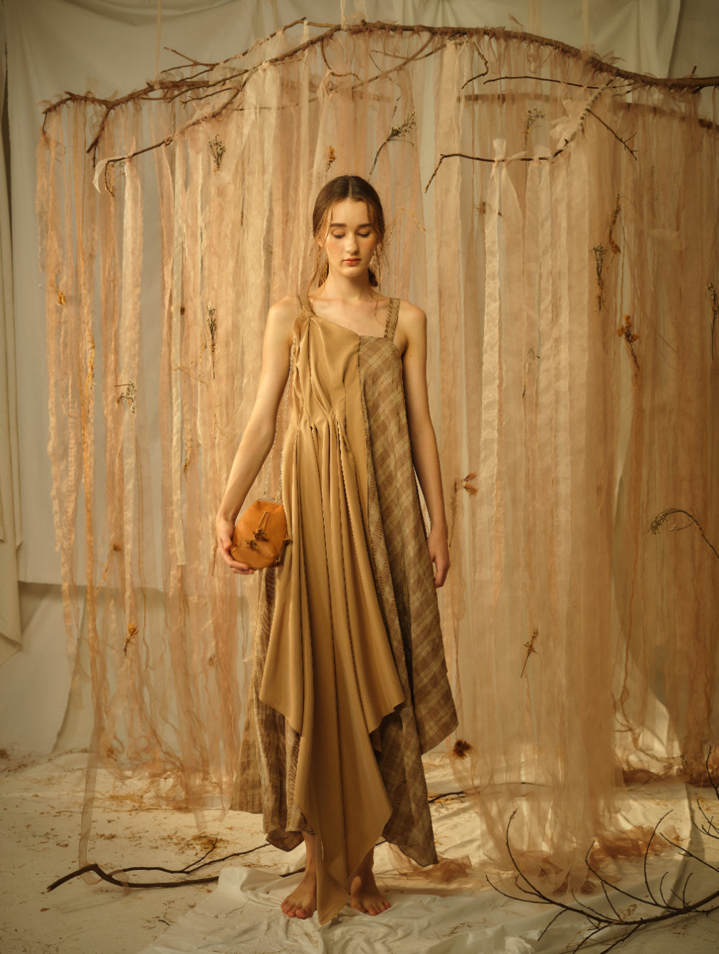 A Tentative Atelier SS21 Lookbook Womens brown and checked draped dress with straps and an orange clutch