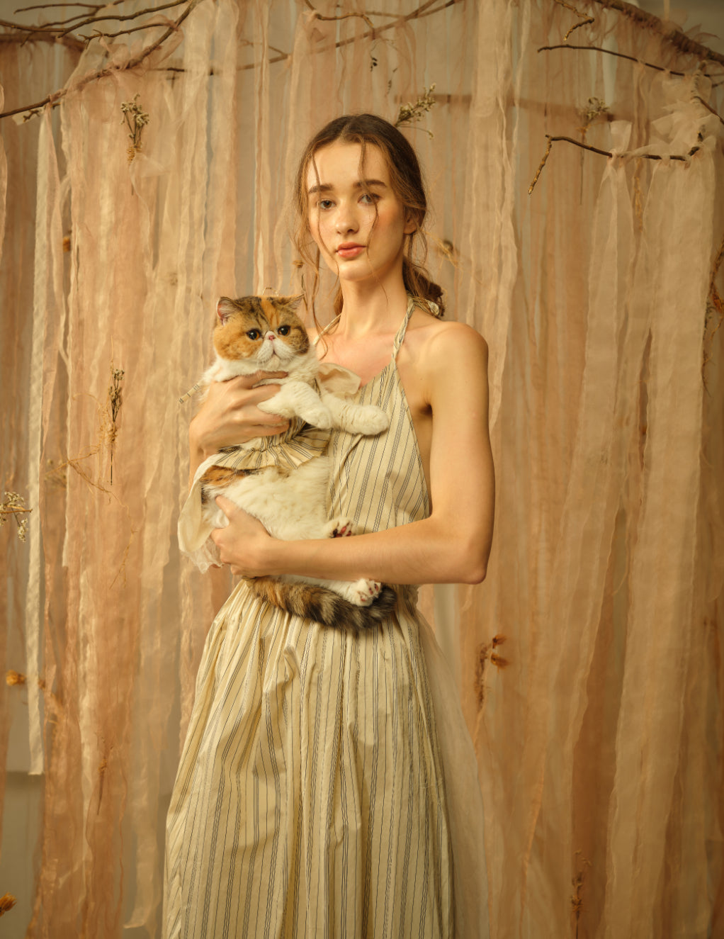A Tentative Atelier SS21 Lookbook Womens crop of a striped halter dress and a cat in matching outfit