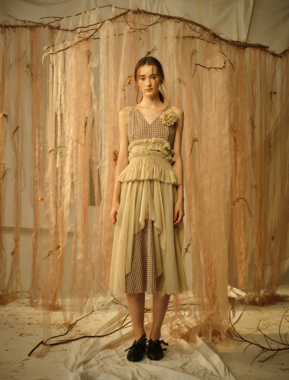 A Tentative Atelier SS21 Lookbook Womens sleeveless brown check dress with smocked, and tulle flower appliqué