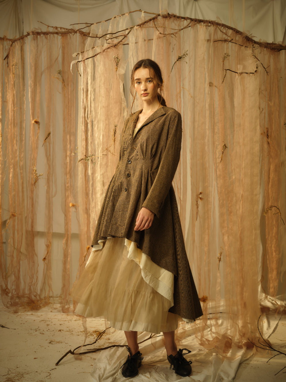 A Tentative Atelier SS21 Lookbook Womens brown high-low hem coat with a pleated waist section