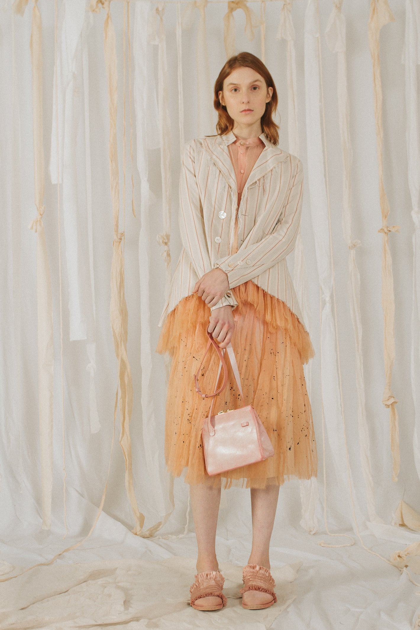 A Tentative Atelier SS18 Lookbook Womens grey striped jacket and orange tulle dress styled with a pink leather cross body bag