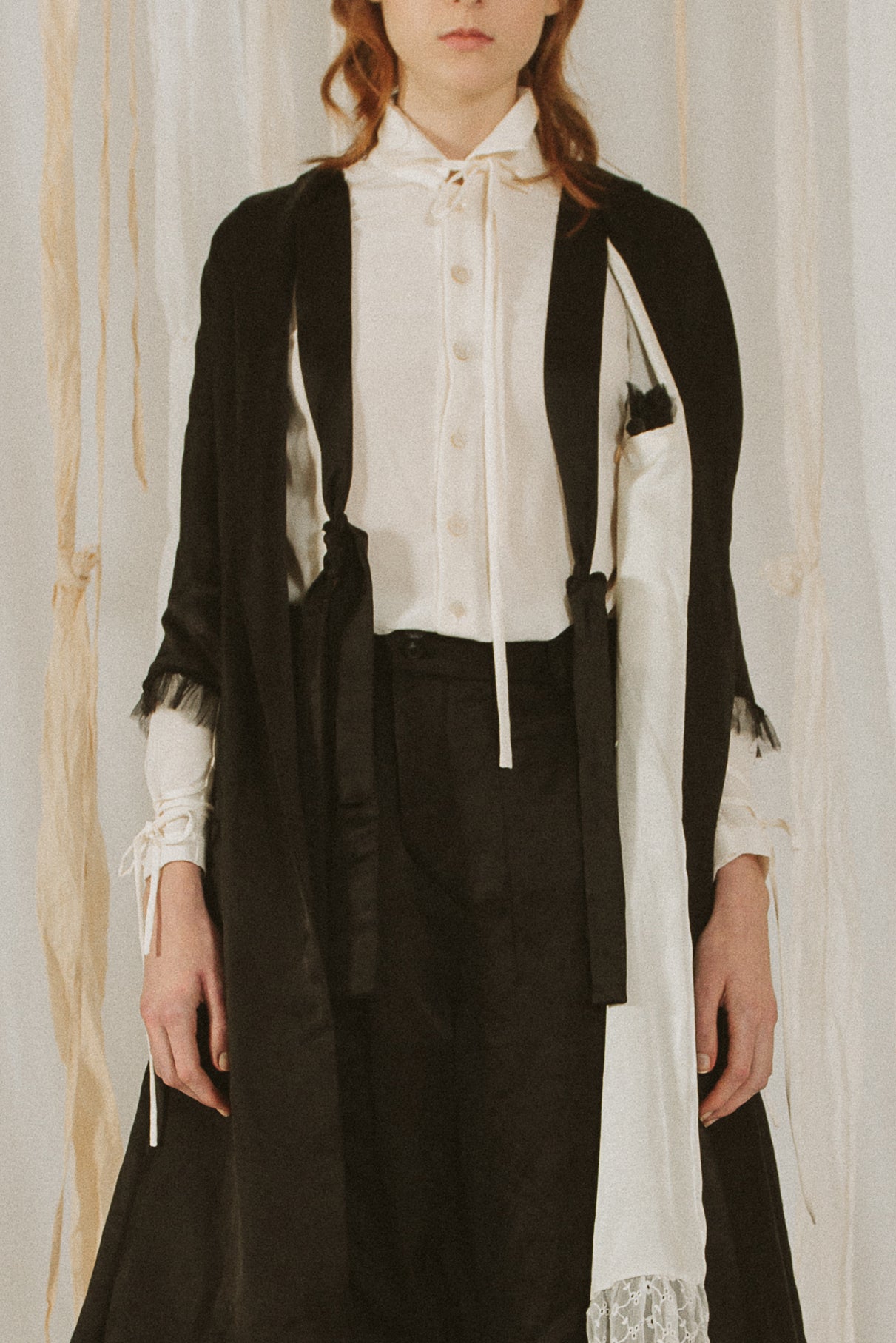 A Tentative Atelier SS18 Lookbook Womens crop of black silk coat with half length sleeves and black tulle trim