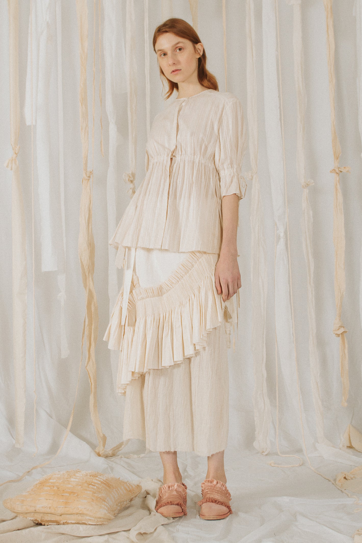 A Tentative Atelier SS18 Lookbook Womens off white half length sleeve top with ruched waist, styled with a ruffle appliqué skirt