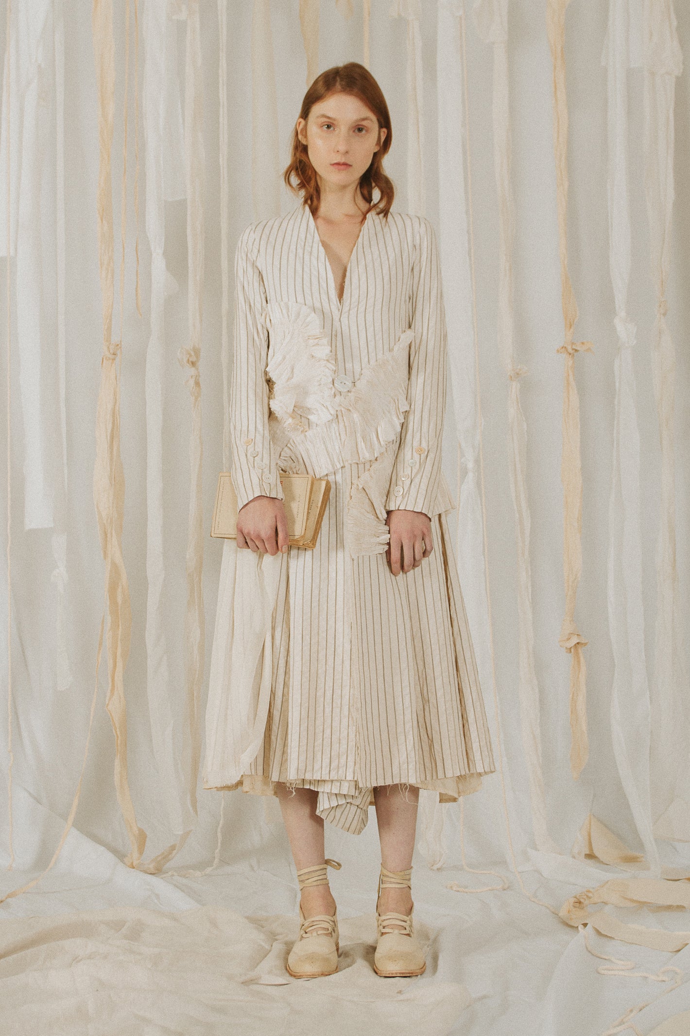 A Tentative Atelier SS18 Lookbook Womens white collarless striped coat with smocked cloth appliqué