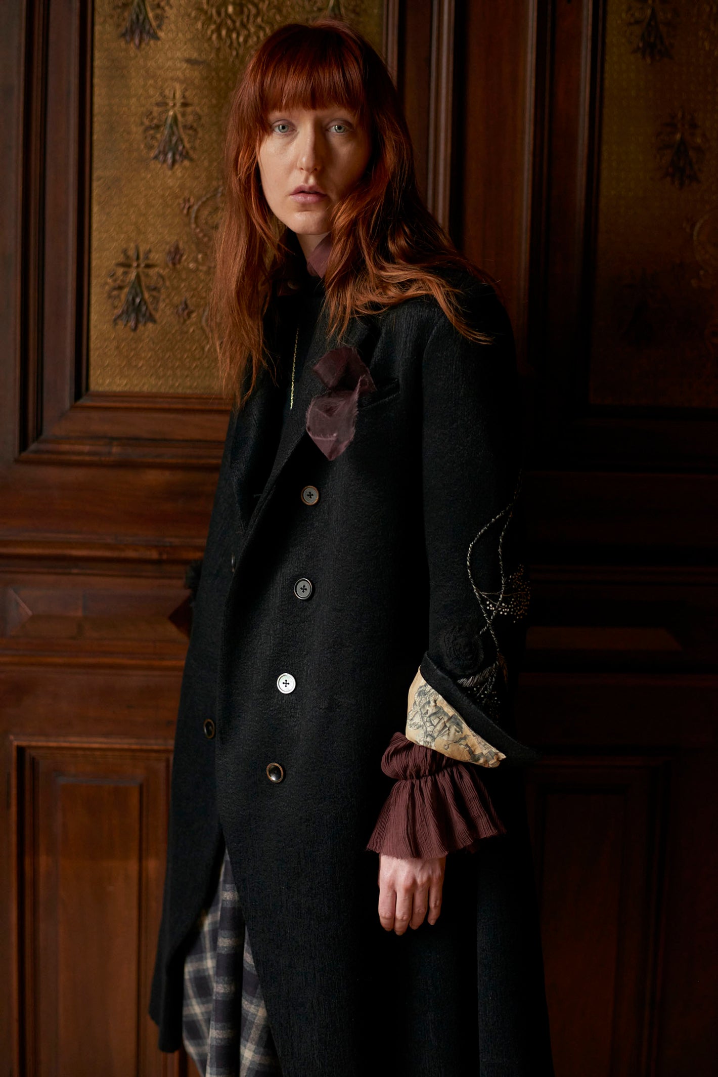 A Tentative Atelier AW20 Lookbook Womens crop of a black coat with white embroidery 