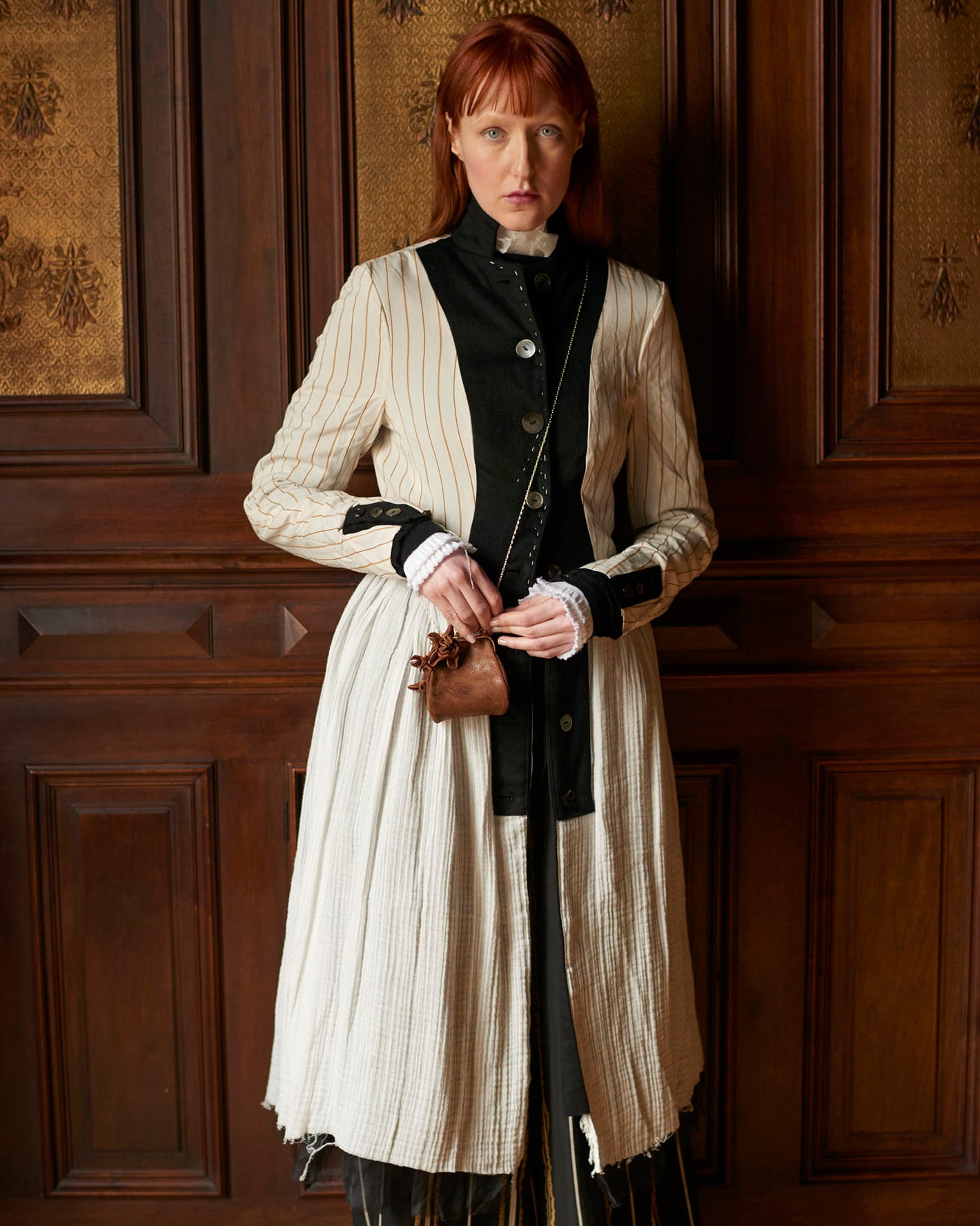 A Tentative Atelier AW20 Lookbook Womens crop of a white striped coat with black placket