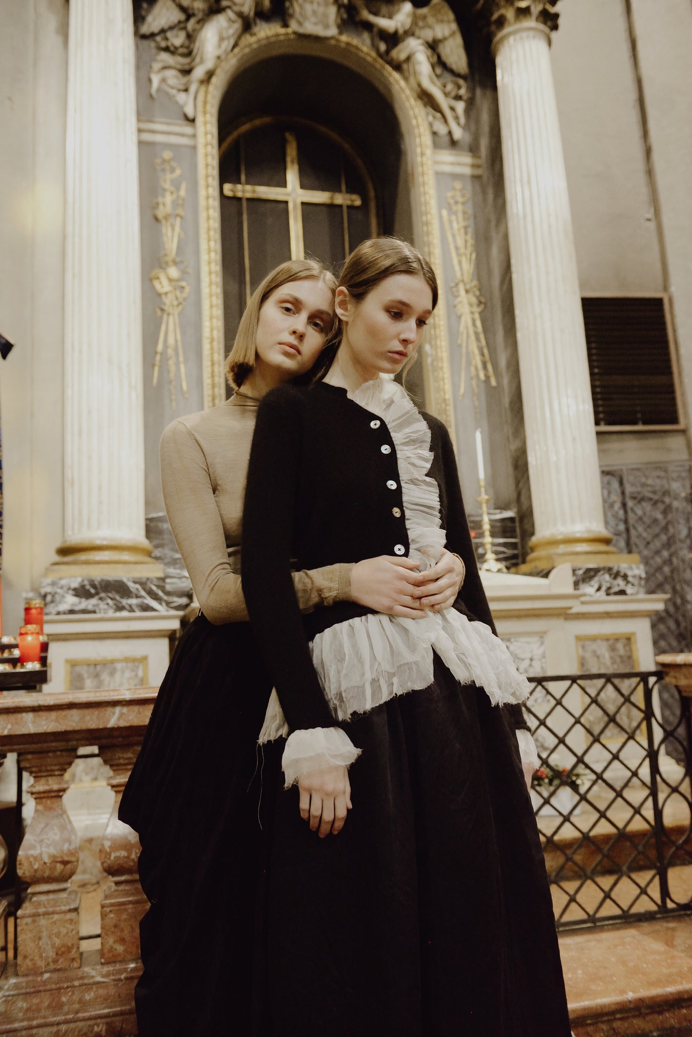 A Tentative Atelier AW19 Lookbook Womens two models, the one in the foreground pictured wearing a black cardigan with white tulle ruffle trim 1