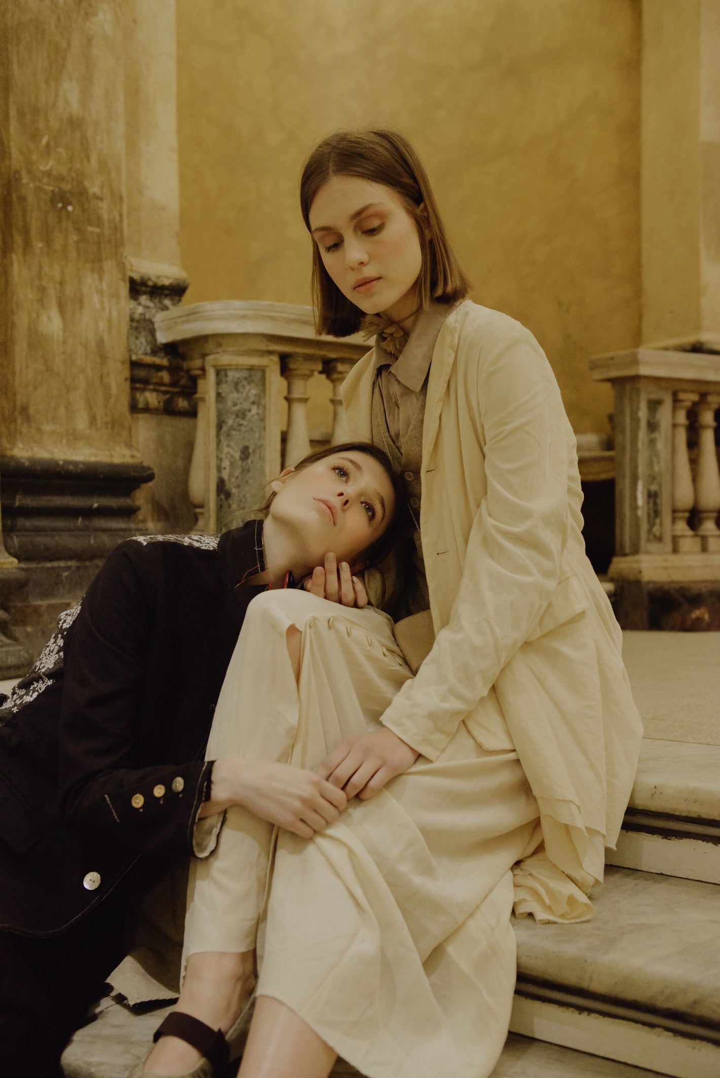 A Tentative Atelier AW19 Lookbook Womens crop of two models wearing a black coat, white coat and dress respectively