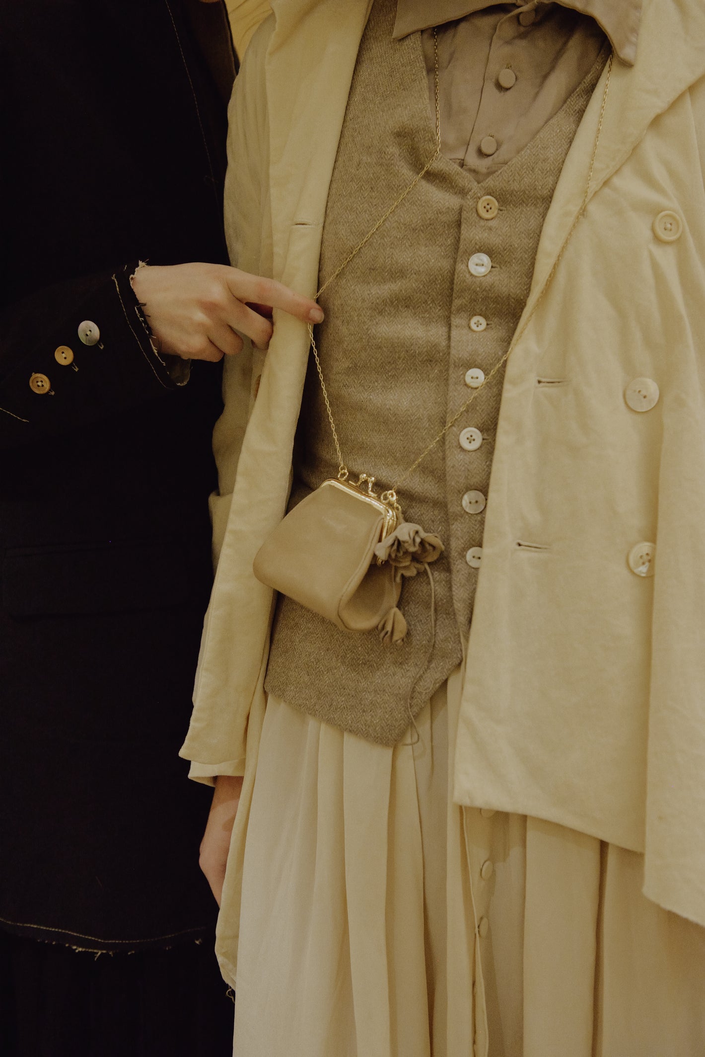 A Tentative Atelier AW19 Lookbook Womens crop of a beige waistcoat and mini chain purse