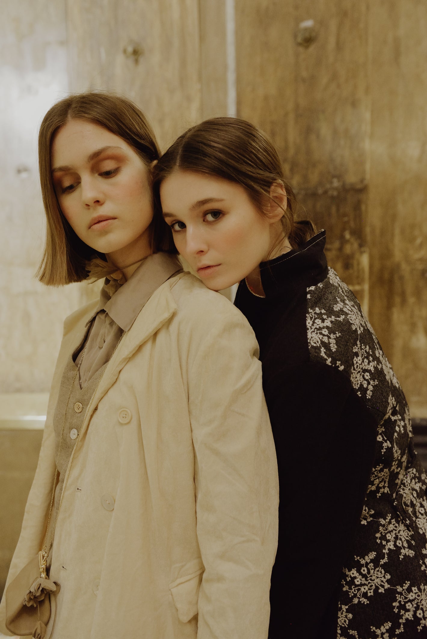 A Tentative Atelier AW19 Lookbook Womens, crop of two models wearing a white coat and black embroidered coat respectively